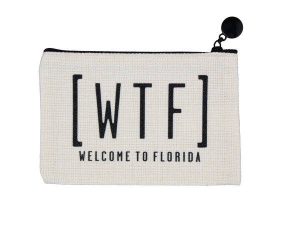 An off-white canvas zippered pouch with black text reading '[WTF] WELCOME TO FLORIDA' and a black zipper pull, shown on a plain white background.