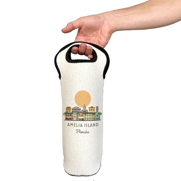 White wine bottle holder with 'Amelia Island, Florida' design held by a hand on a white background