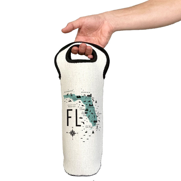 Hand holding a white wine bottle bag with 'FL' and map design on a white background