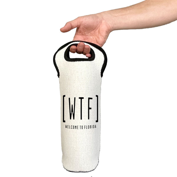 White wine bottle holder with 'WTF' text held by a hand on a white background