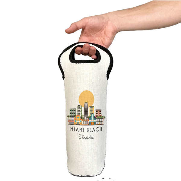 Hand holding a white wine bottle bag with 'Miami Beach, Florida' design on a white background