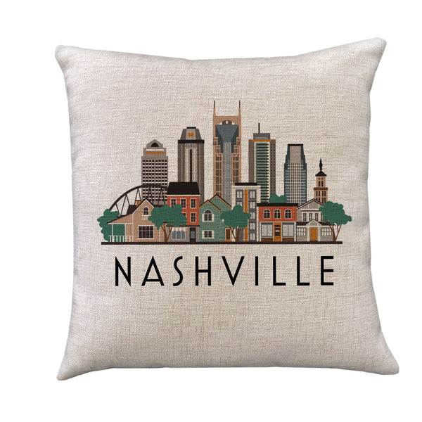 A square throw pillow in a textured beige linen fabric, featuring a stylized graphic of the Nashville skyline with the word 'NASHVILLE' printed in black below it, set against a plain white background.
