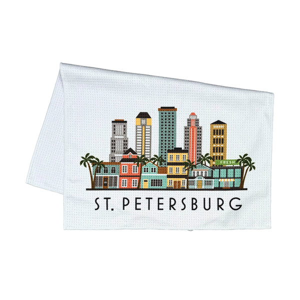 A white kitchen towel with a colorful St. Petersburg skyline graphic and the text 'ST.